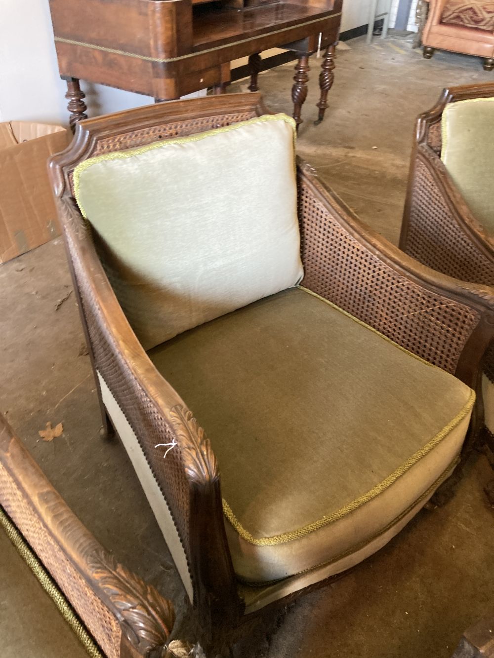 A 1920s carved beech four piece bergere suite